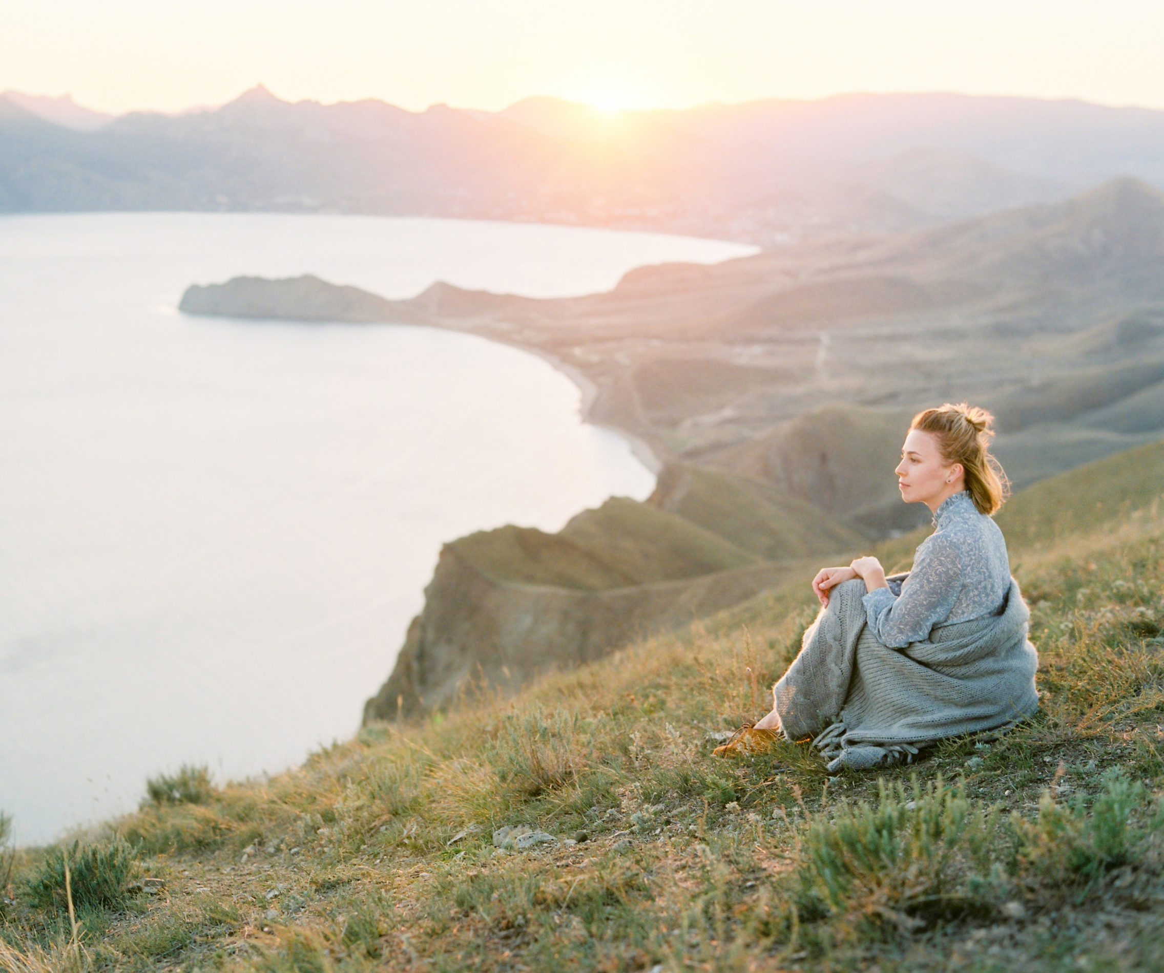 Freedom woman in free happiness bliss open arms at mountain peak. Happy female model in summer dress enjoying serene ocean nature during. Freedom and healthy concept.